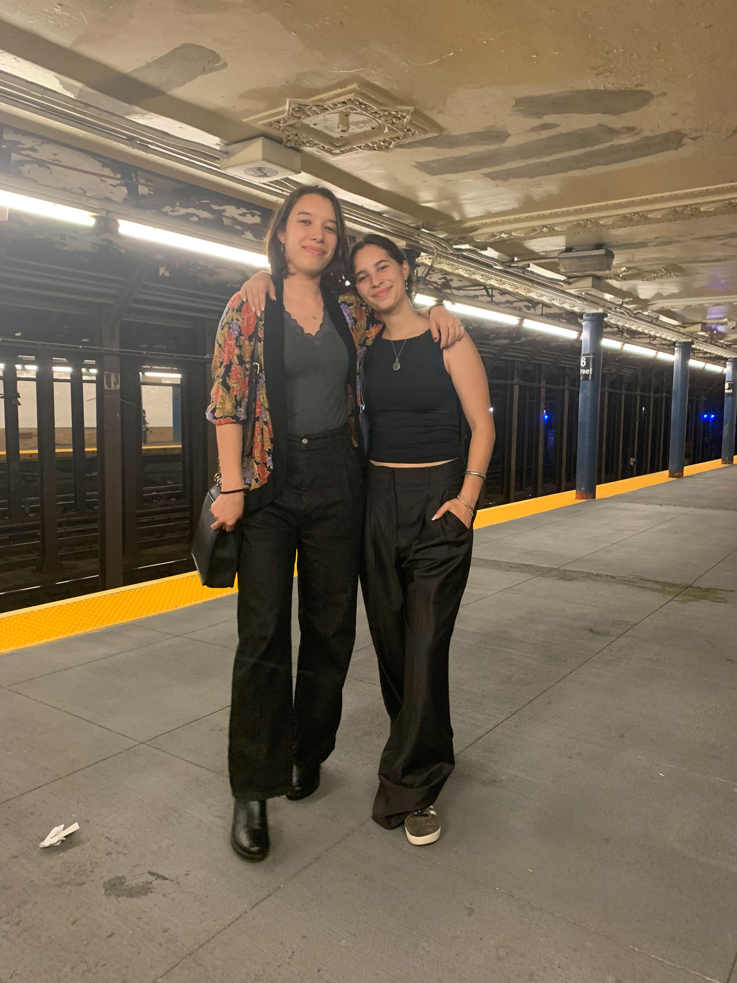 Two women stand in NYC subway